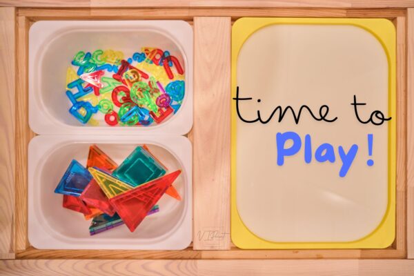 light table insert used on an IKEA Flisat sensory table, working as a functional light table cheap alternatives. Paired with magnetic tiles and transparent colored letters